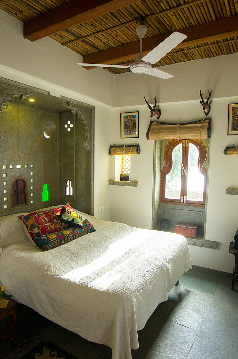 The bedroom has a luxury king size bed with hand made cotton mattress and the window looks out over the lake.