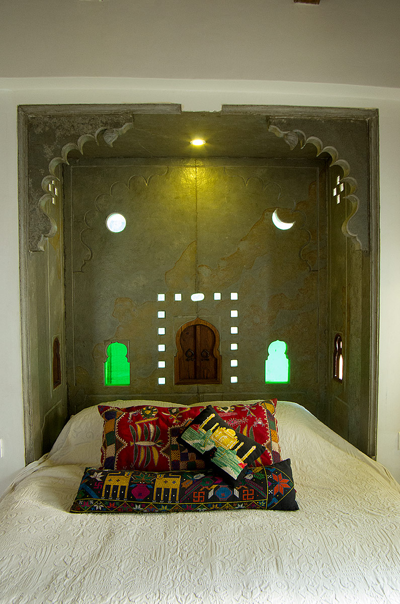 The bedroom has a luxury king size bed with hand made cotton mattress and the window looks out over the lake.